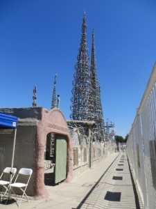 watts towers behind fence